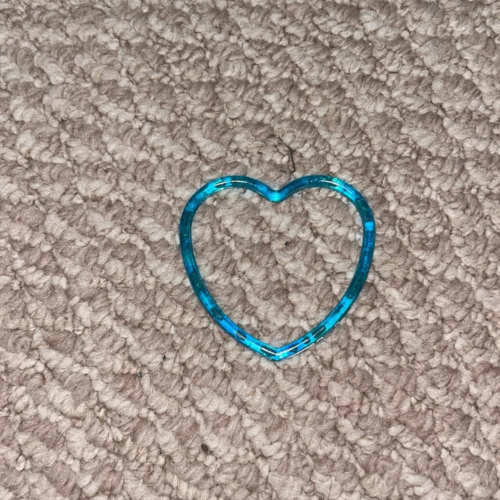 Blue heart bracelet, two purple, one green one yellow jelly bands and two more